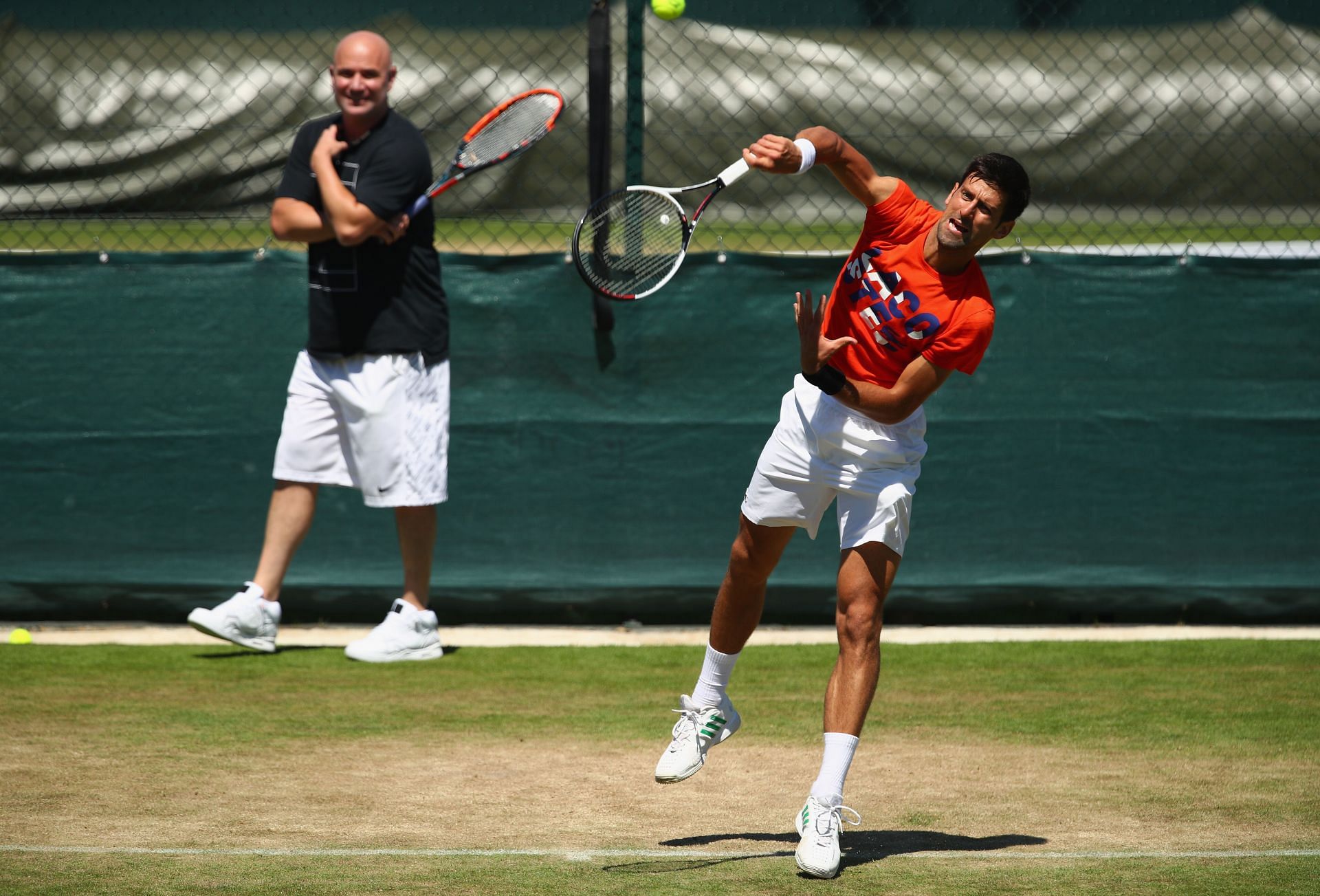 Andre Agassi and Novak Djokovic on the practice courts at Wimbledon