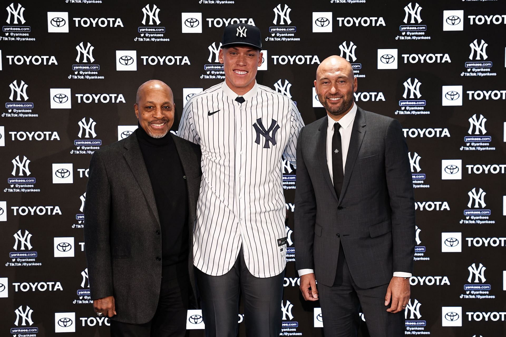 Former New York Yankees captains Willie Randolph and Derek Jeter pose for a photo with Aaron Judge