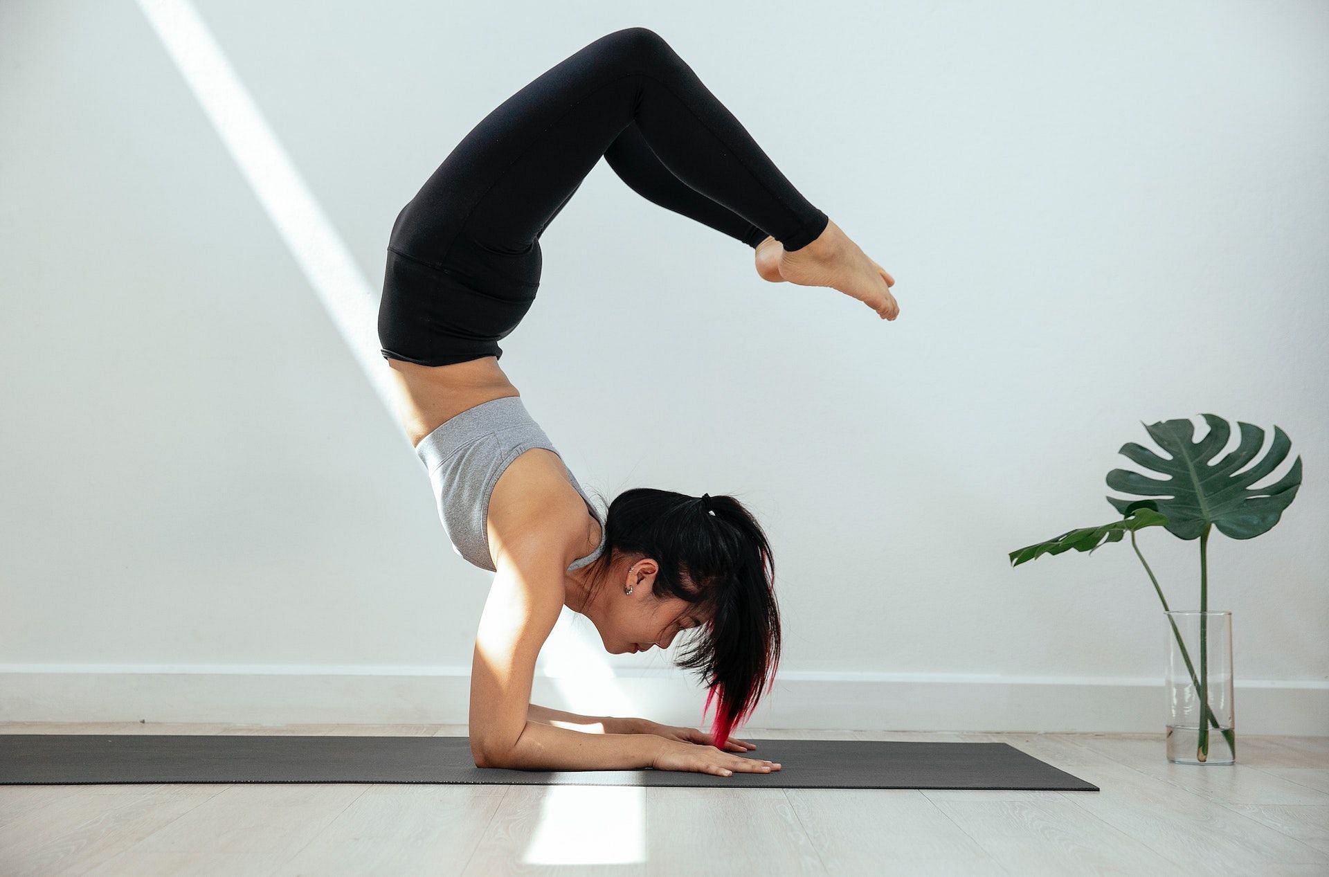 Young Woman Practicing Yoga, Standing In Vrischikasana Scorpion Pose At The  Yoga Studio Stock Photo, Picture and Royalty Free Image. Image 94249563.