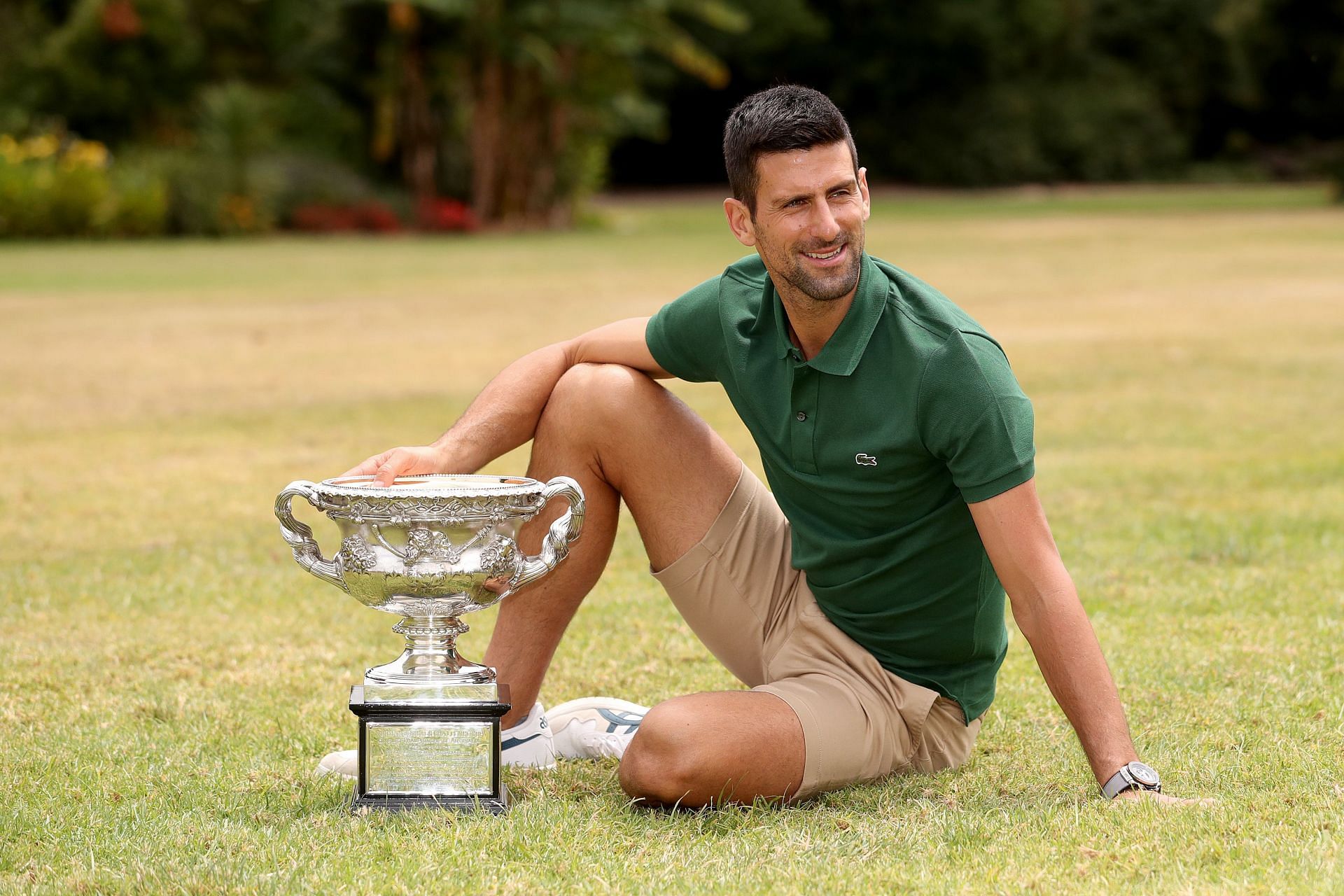Novak Djokovic poses with the Australian Open trophy during his champions&#039; photoshoot