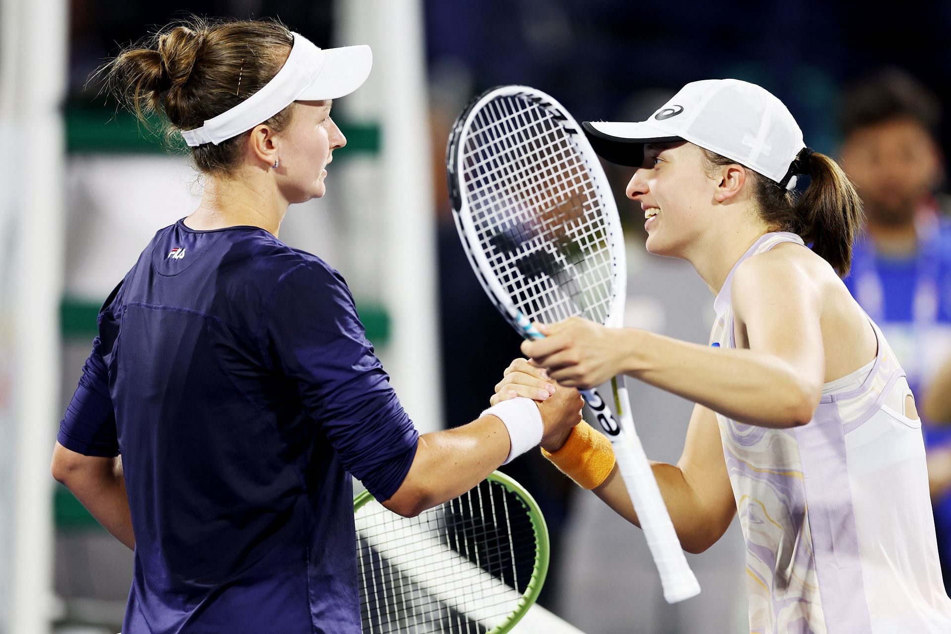 Barbora Krejcikova and Iga Swiatek greet each other after their 2023 Dubai Tennis Championships final.