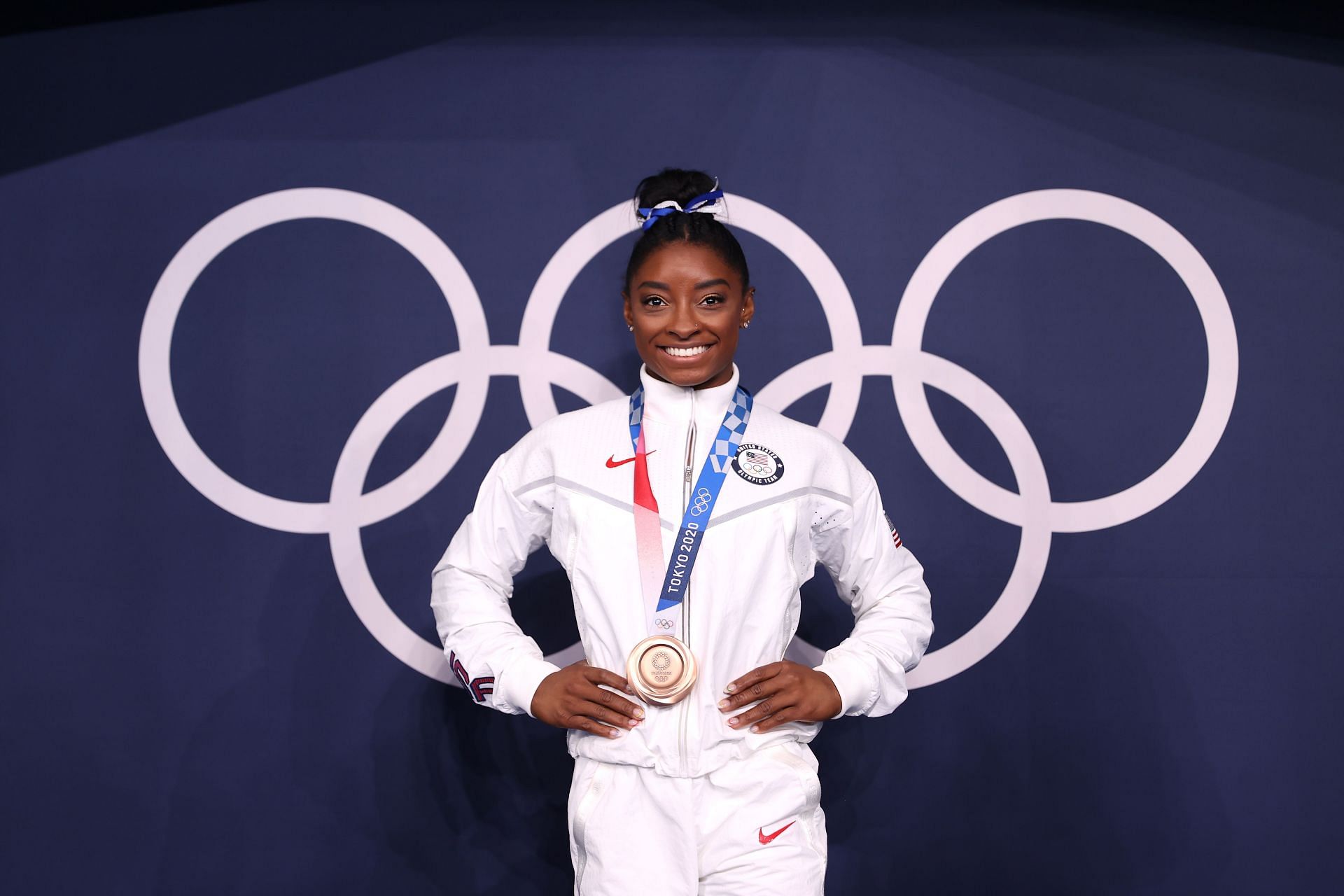 Simone Biles poses with the bronze medal at the 2020 Tokyo Olympics