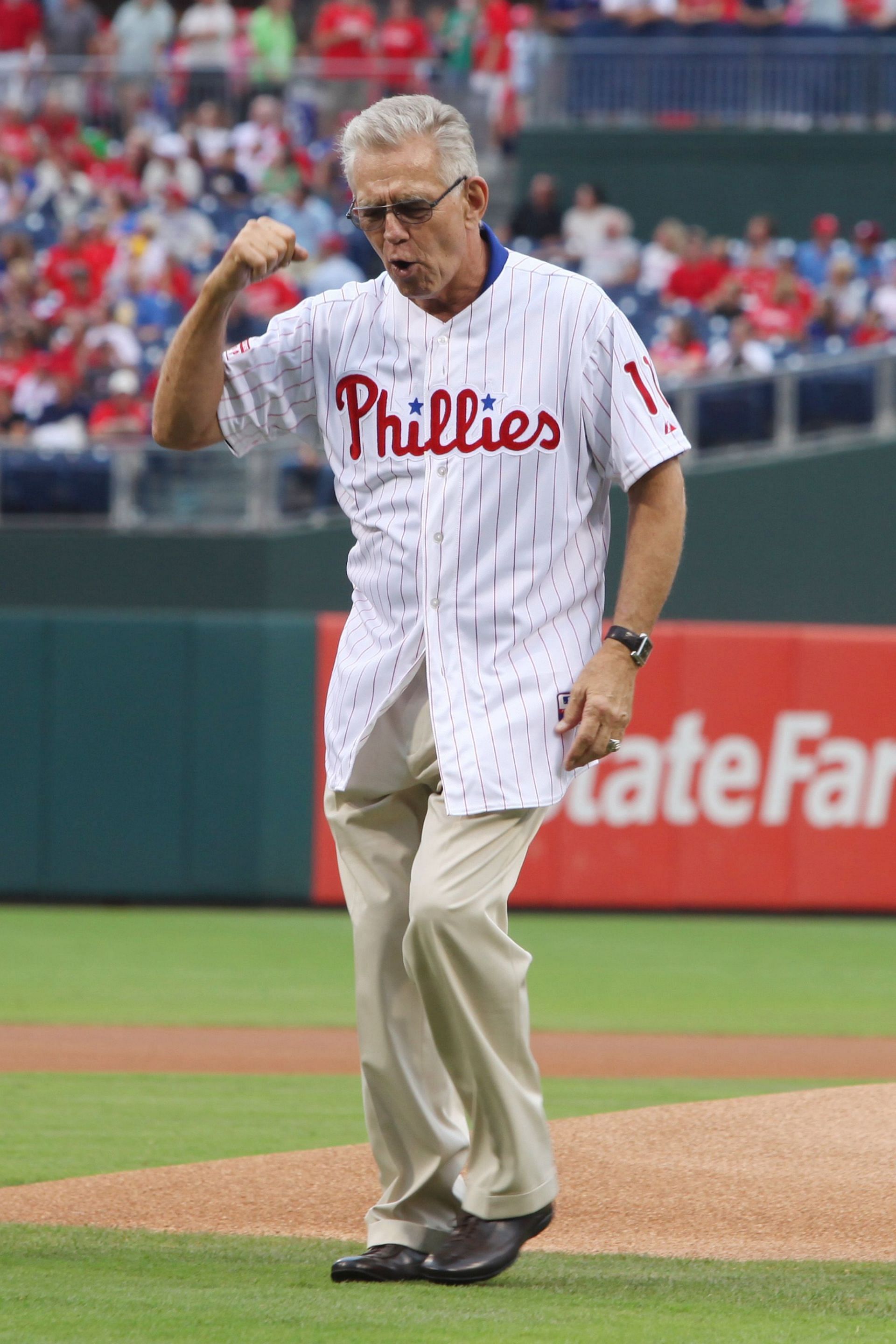 Former Philadelphia Phillie Tim McCarver walks off the mound after throwing out the ceremonial first pitch before a game between the Philadelphia Phillies and the St. Louis Cardinals