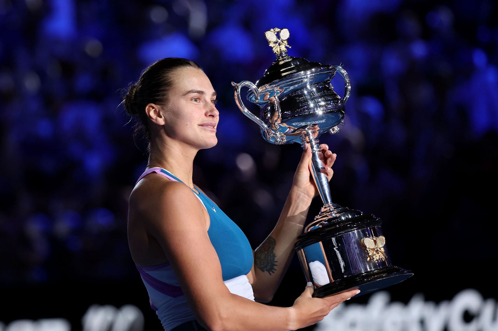 Aryna Sabalenka poses with the Daphne Akhurst Memorial Cup after winning the 2023 Australian Open.