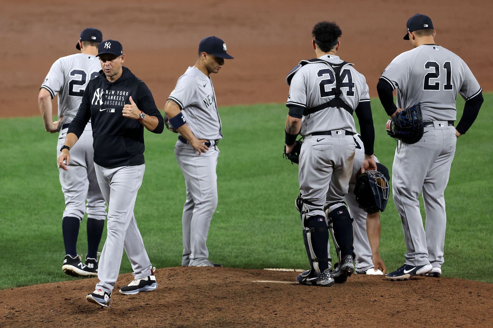 Manager Aaron Boone of the New York Yankees walks off the mound during a pitching change against the Baltimore Orioles