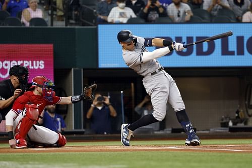 Aaron Judge #99 of the New York Yankees hits his 62nd home run of the season against the Texas Rangers during the first inning in game two of a double header at Globe Life Field on October 4, 2022, in Arlington, Texas. Judge has now set the American League record for home runs in a single season.