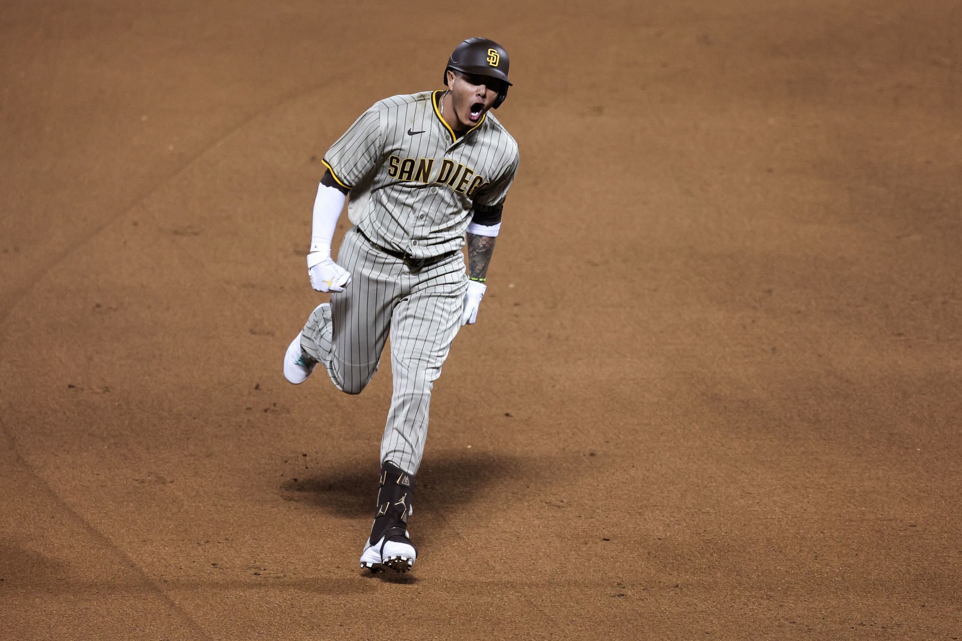 Manny Machado of the San Diego Padres rounds the bases after