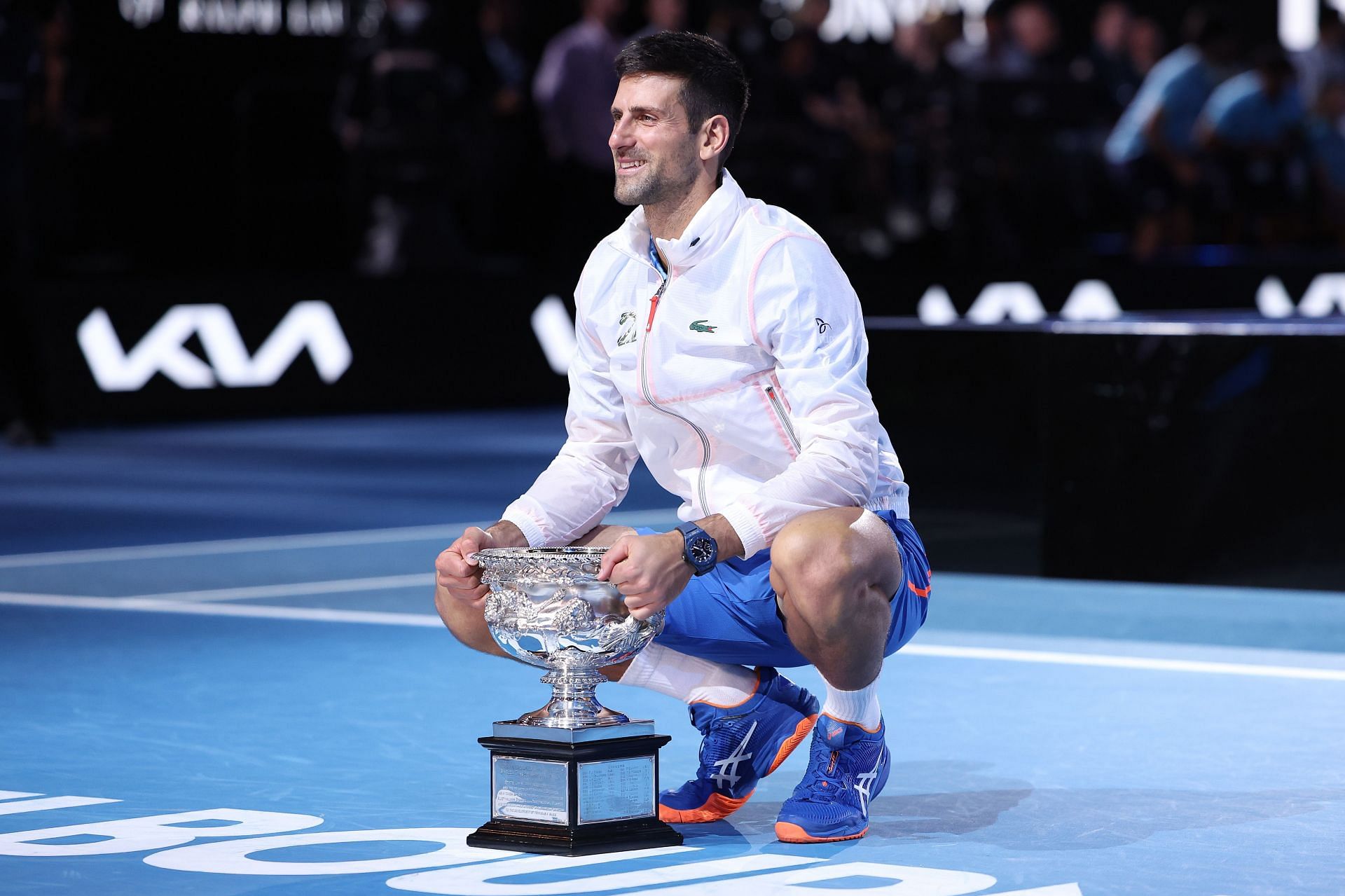 Novak Djokovic poses with the 2023 Australian Open trophy.
