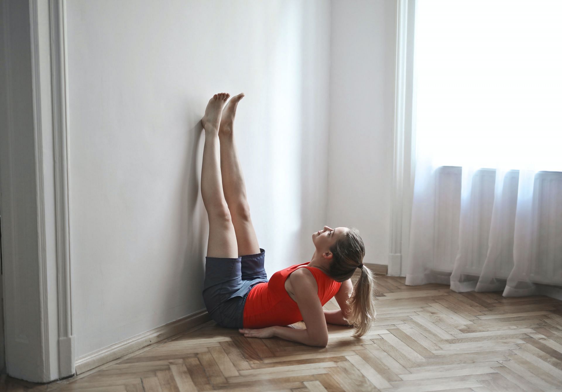 Legs up the wall pose has been recently trending for its benefits. (Image via Pexels/ Andrea Piacquadio)