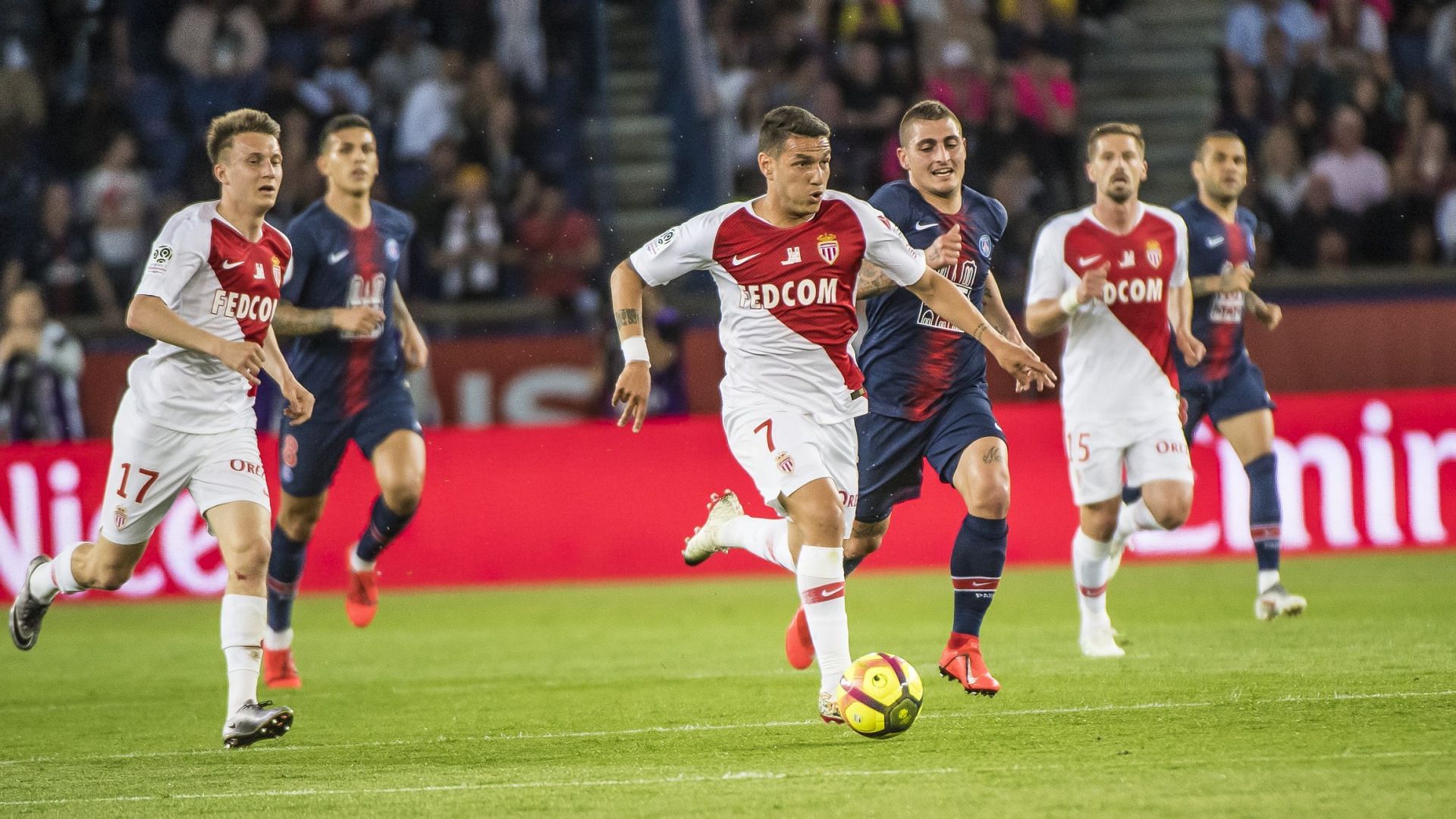 Monaco and PSG players tussle for the ball in midfield during their Ligue 1 clash.