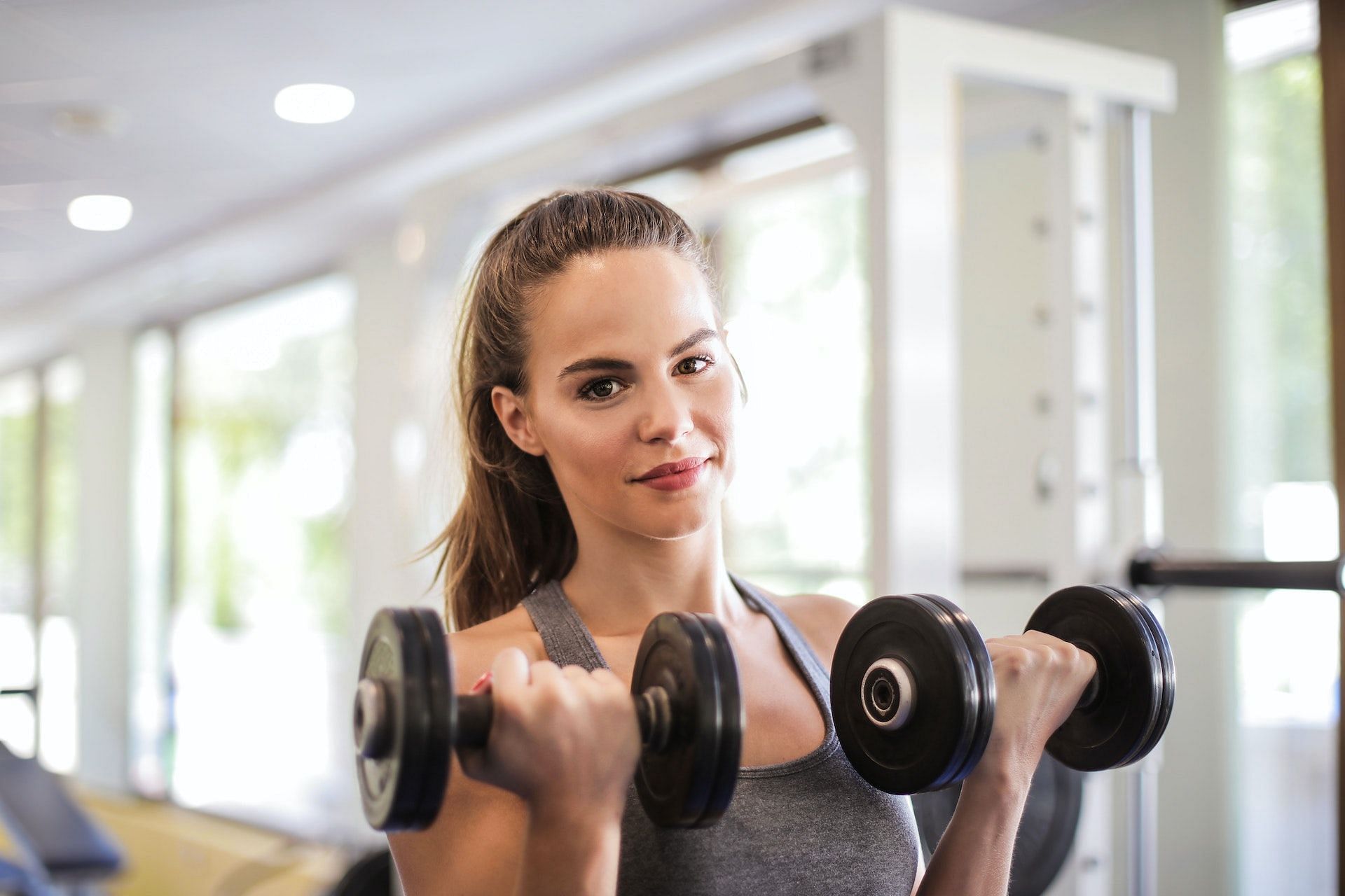 Full-body dumbbell workouts target the major muscles in the body. (Photo via Pexels/Andrea Piacquadio)