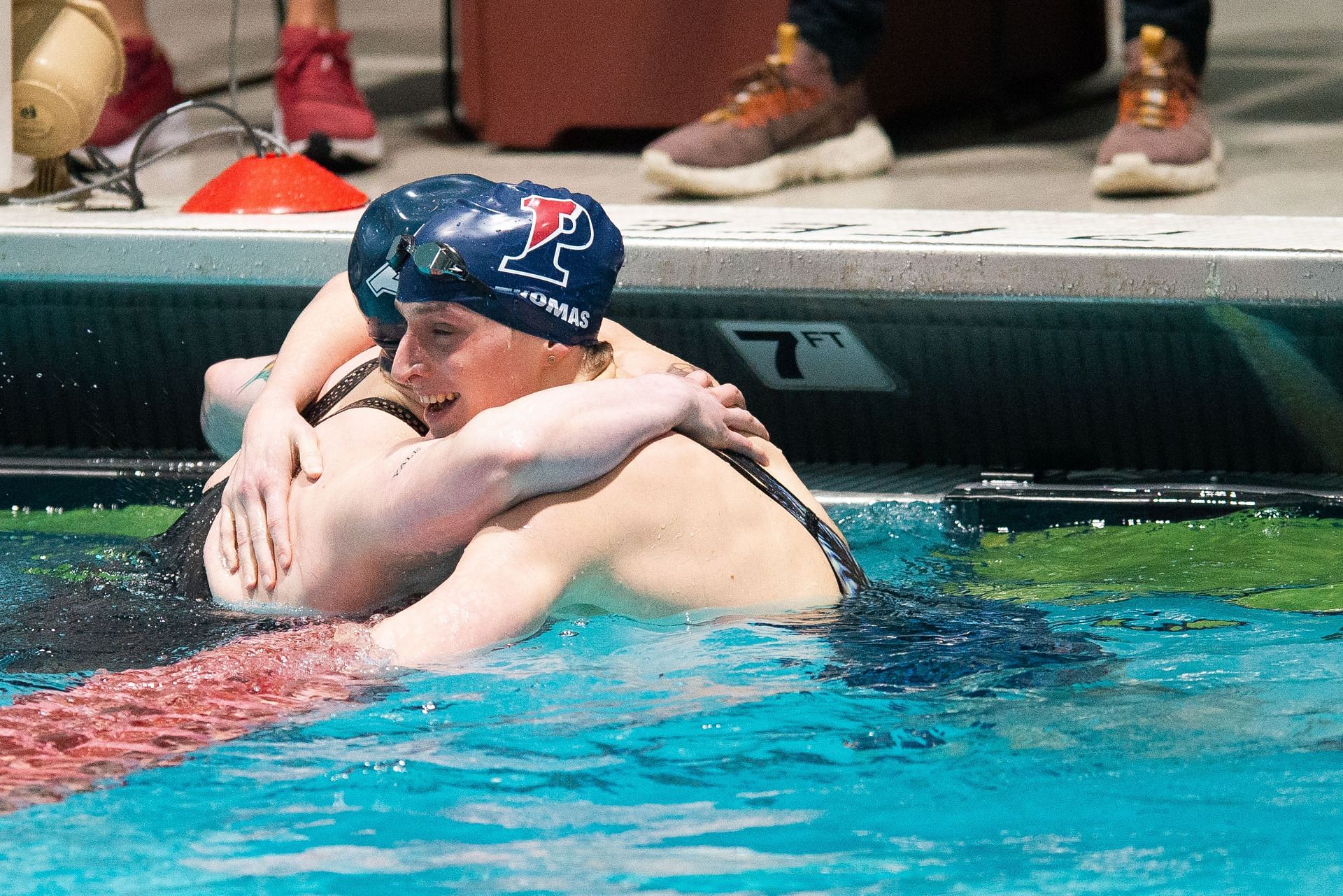 University of Pennsylvania swimmer Lia Thomas hugs Yale University swimmer Iszac Henig (Photo by Kathryn Riley/Getty Images)
