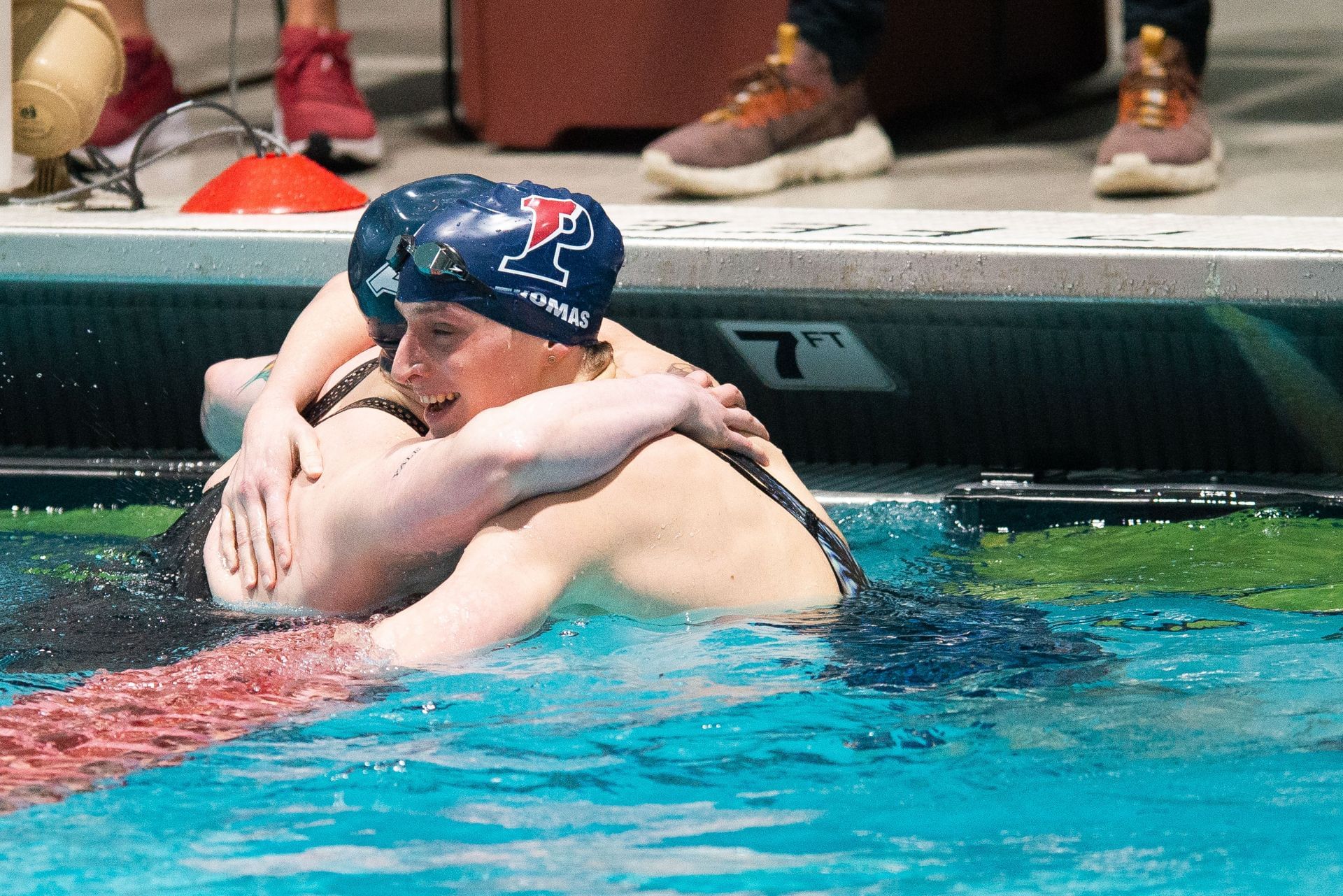 University of Pennsylvania swimmer Lia Thomas hugs Yale University swimmer Iszac Henig (Photo by Kathryn Riley/Getty Images)