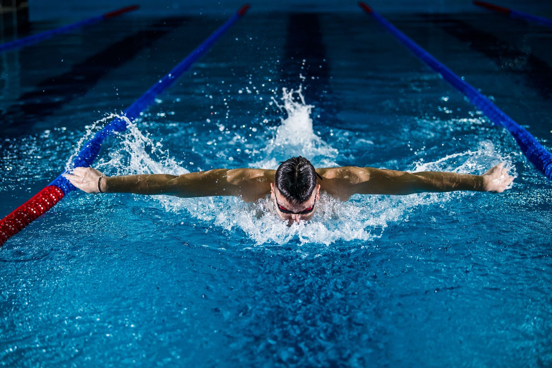 Strength training can make you better at swimming. (Image via Unsplash/Gentri Sylejmani)