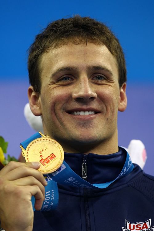 Ryan Lochte of the United States poses with his gold medal after winning a new world record time on the Men's 200m Individual Medley Final during Day Thirteen of the 14th FINA World Championships at the Oriental Sports Center on July 28, 2011, in Shanghai, China. (Photo by Quinn Rooney/Getty Images)