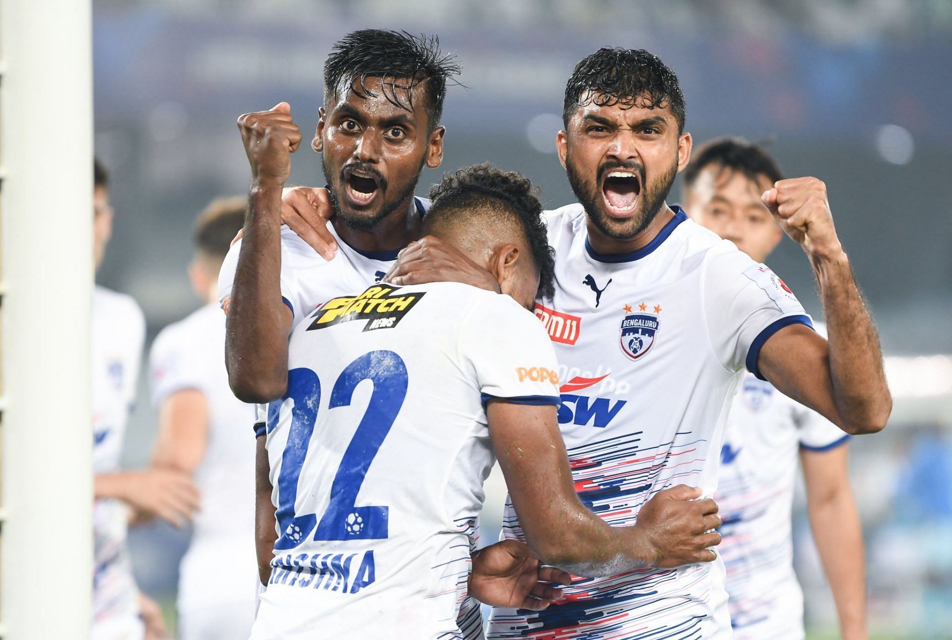 Parag and Rohit celebrate with Roy Krishna following Bengaluru