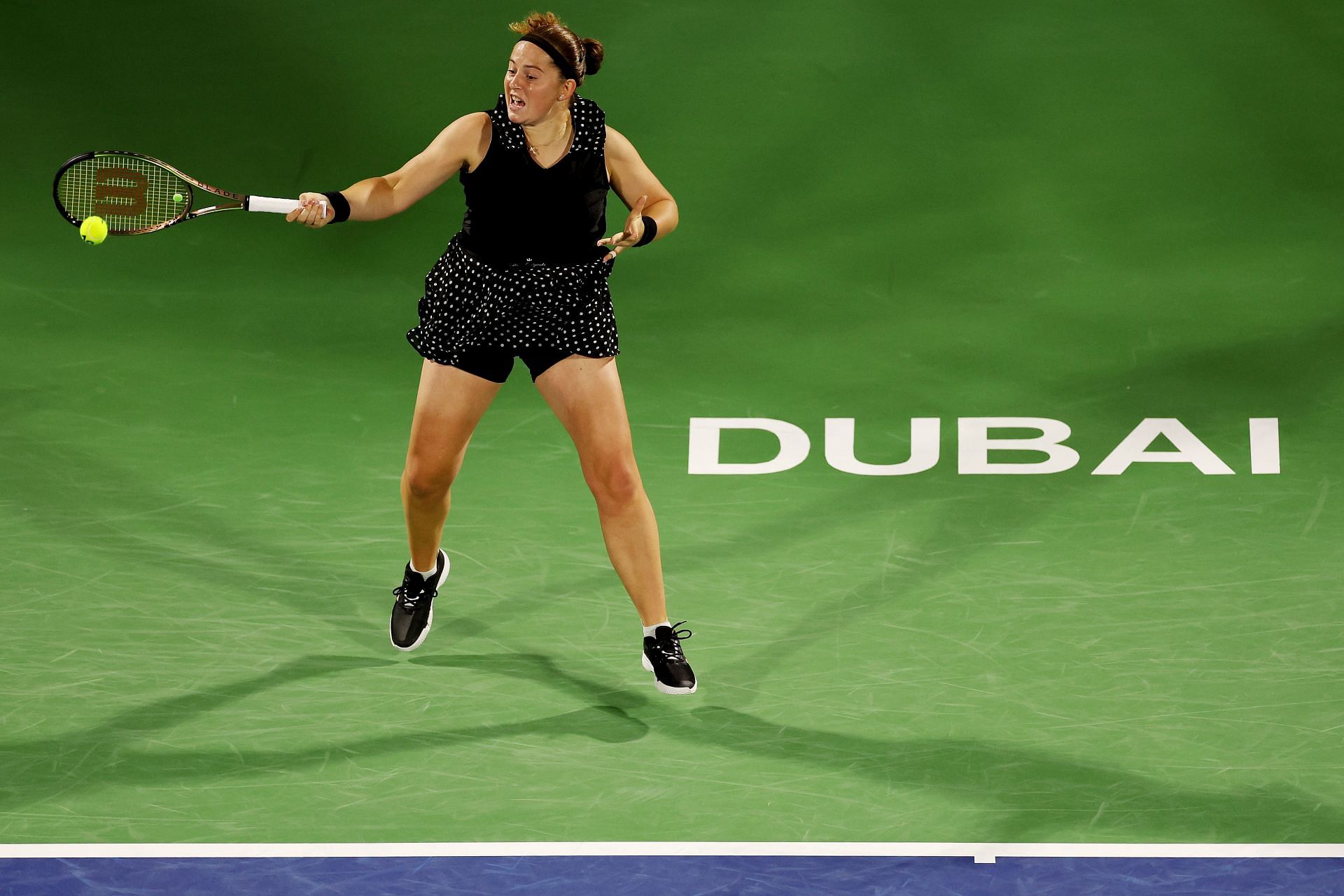 Ostapenko strikes the ball in Dubai