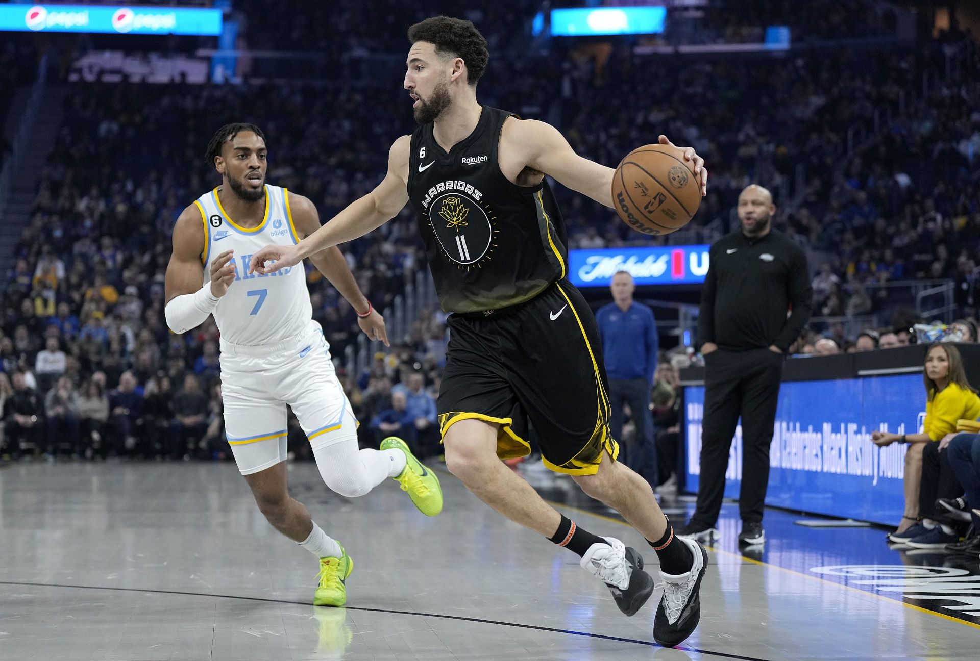 Golden State Warriors star shooting guard Klay Thompson (right) goes up against LA Lakers' Troy Brown Jr.