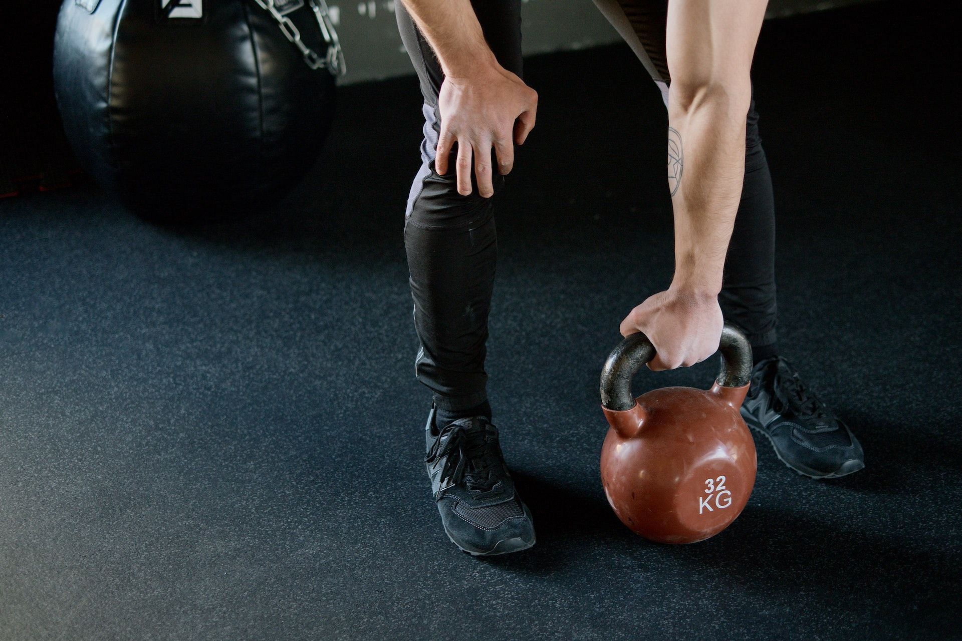 Kettlebell Turkish get-up is one of the most strengthening arm workouts with weights. (Photo via Pexels/Ivan Samkov)