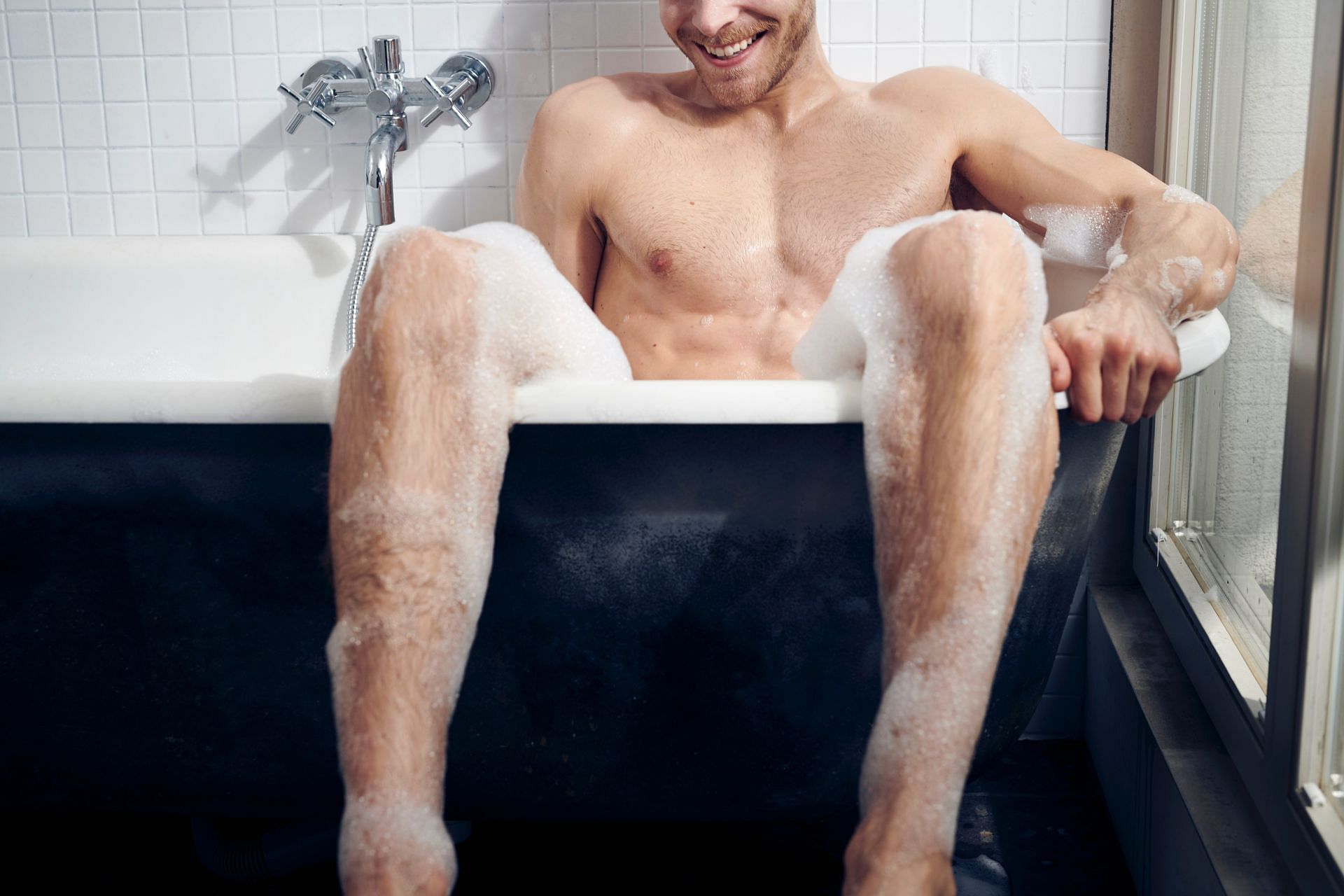 Man enjoying hot water bath. (Image via Unsplash/ We-vibe toys)