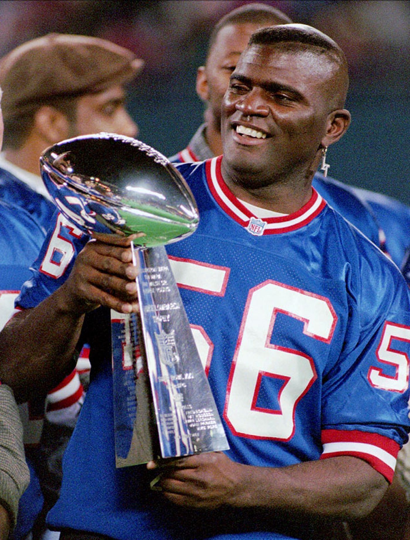 Lawrence Taylor holding the Lombardi Trophy
