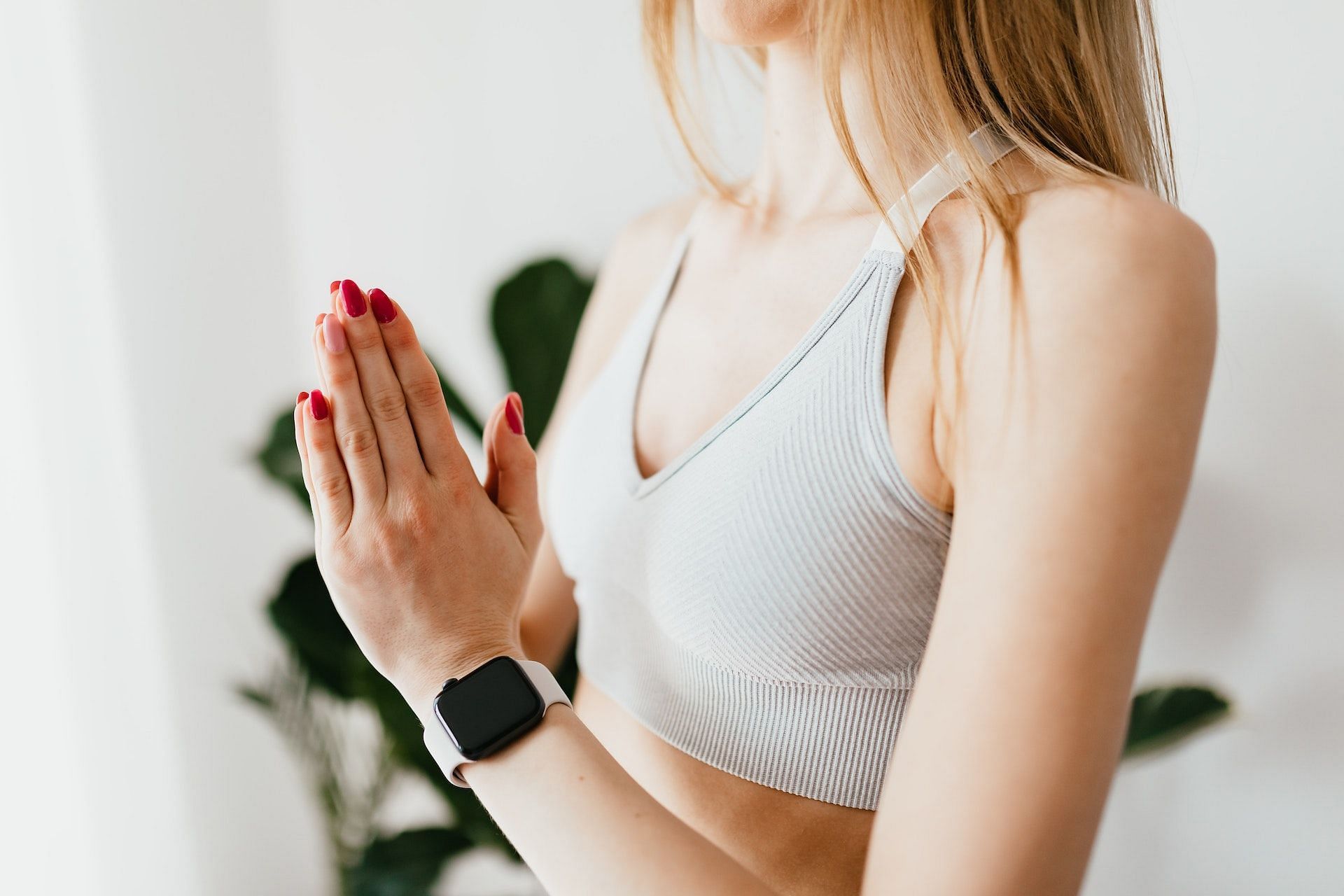 The prayer position stretches the muscles in the forearms and wrists and provides relaxation. (Photo via Pexels/Karolina Grabowska)