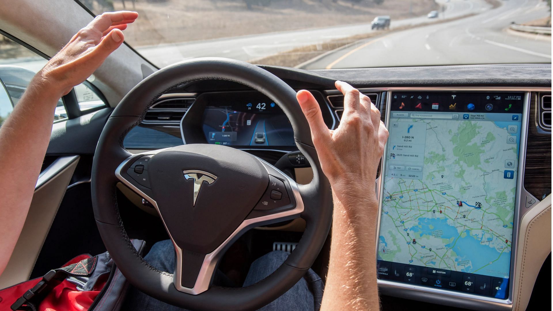 the FSD beta program does not make Tesla cars autonomous and they may still require human intervention (Image via Bloomberg/Getty Images)