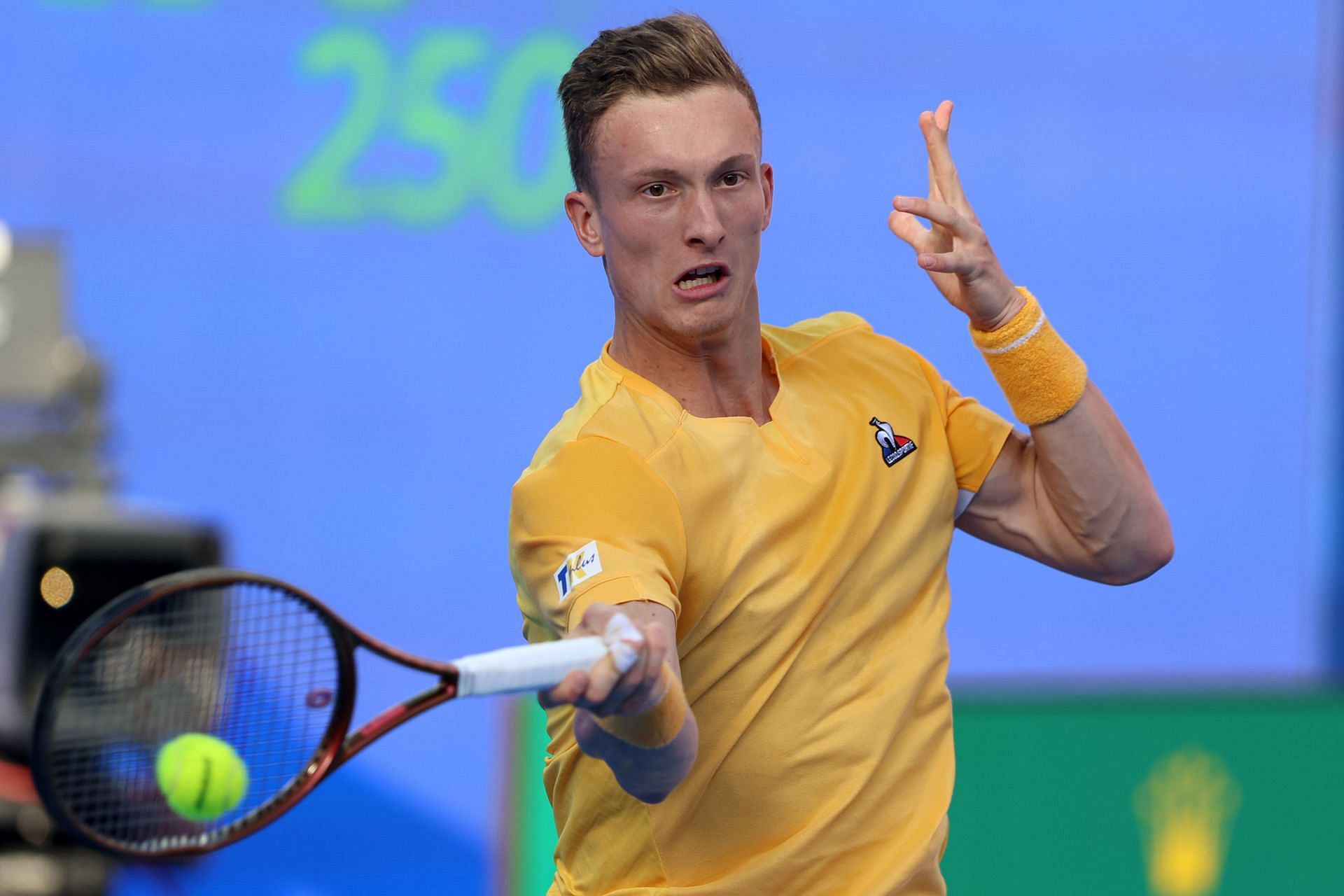 Lehecka strikes the ball at the Qatar ExxonMobil Open.