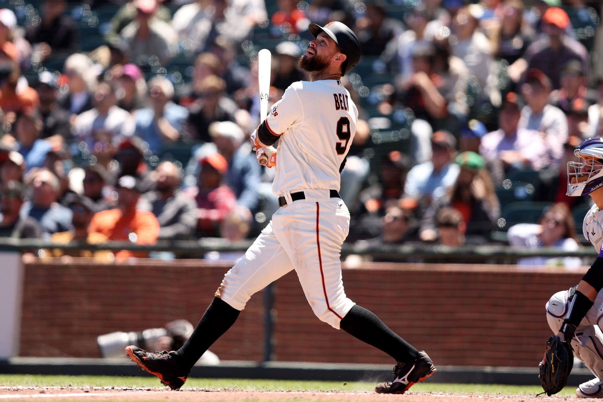 Brandon Belt #9 of the San Francisco Giants hits a sacrifice fly that scored a run