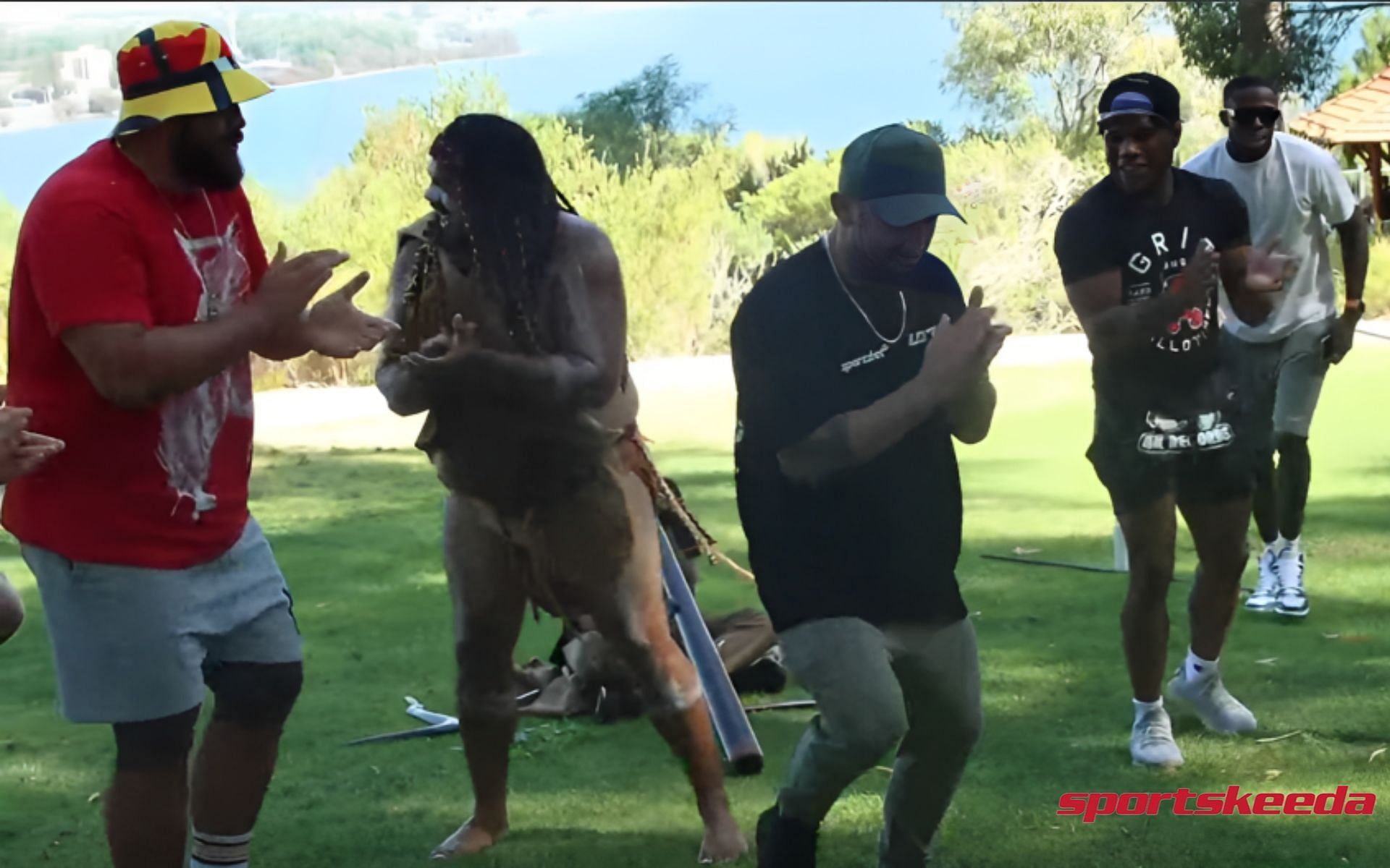 Alexander Volkanovski and Tai Tuivasa dancing with aboriginals