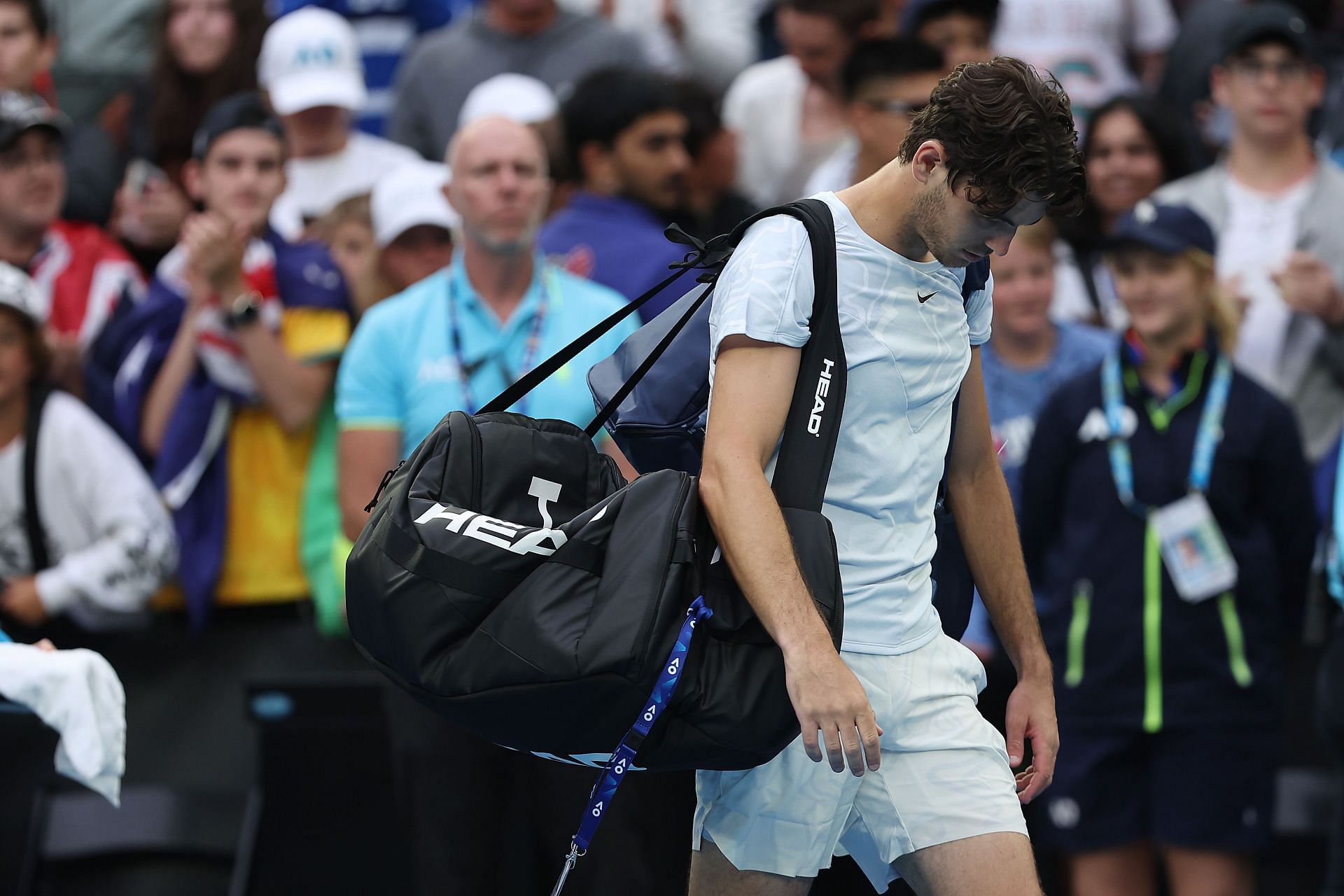 A dejected Taylor Fritz leaves the court after 2023 Australian Open defeat to Alexei Popyrin.