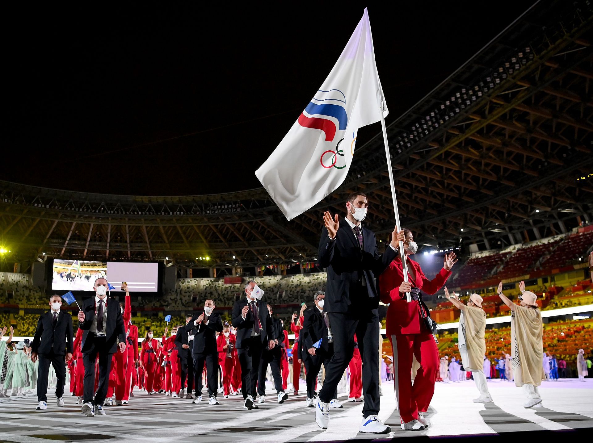 Flag bearers Sofya Velikaya and Maxim Mikhaylov of Team ROC lead their team in during the Opening Ceremony of the Tokyo 2020 Olympic Games