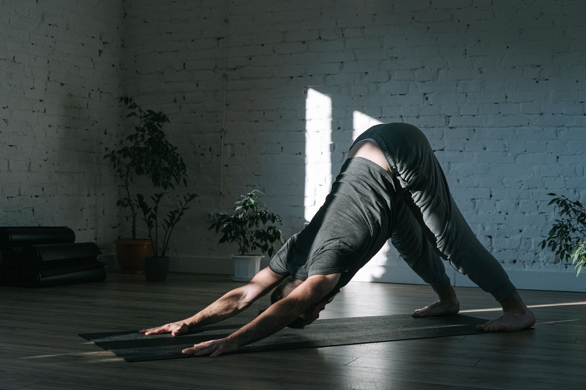 Downward-facing dog pose gently stretches the calves and ease tightness. (Photo via Pexels/Ivan Samkov)