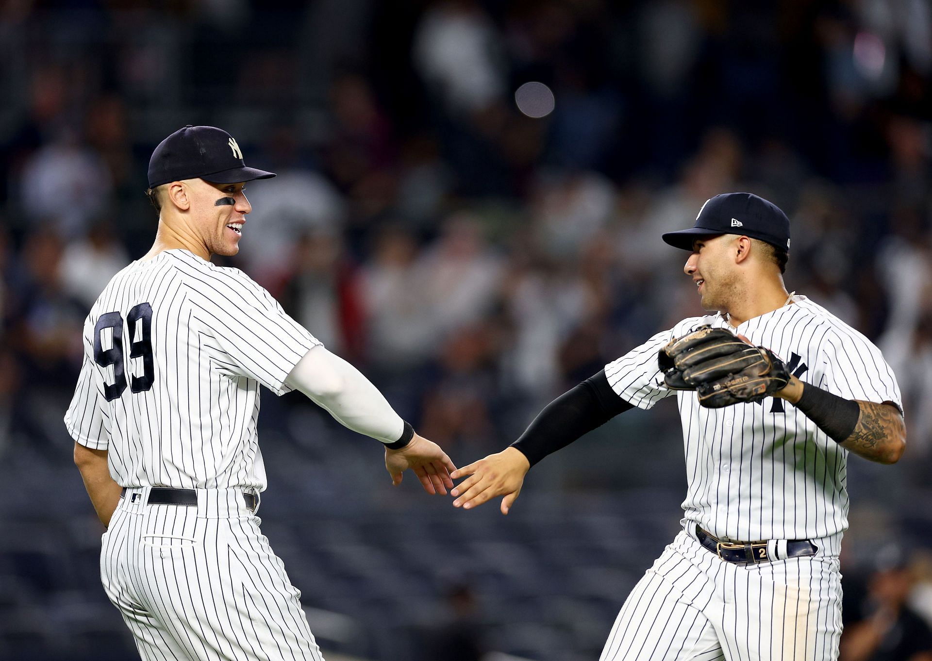 Aaron Judge #99 of the New York Yankees celebrates the win with teammate Gleyber Torres #25 after the game against the Pittsburgh Pirates at Yankee Stadium on September 21, 2022, in the Bronx borough of New York City. The New York Yankees defeated the Pittsburgh Pirates 14-2. (Photo by Elsa/Getty Images)