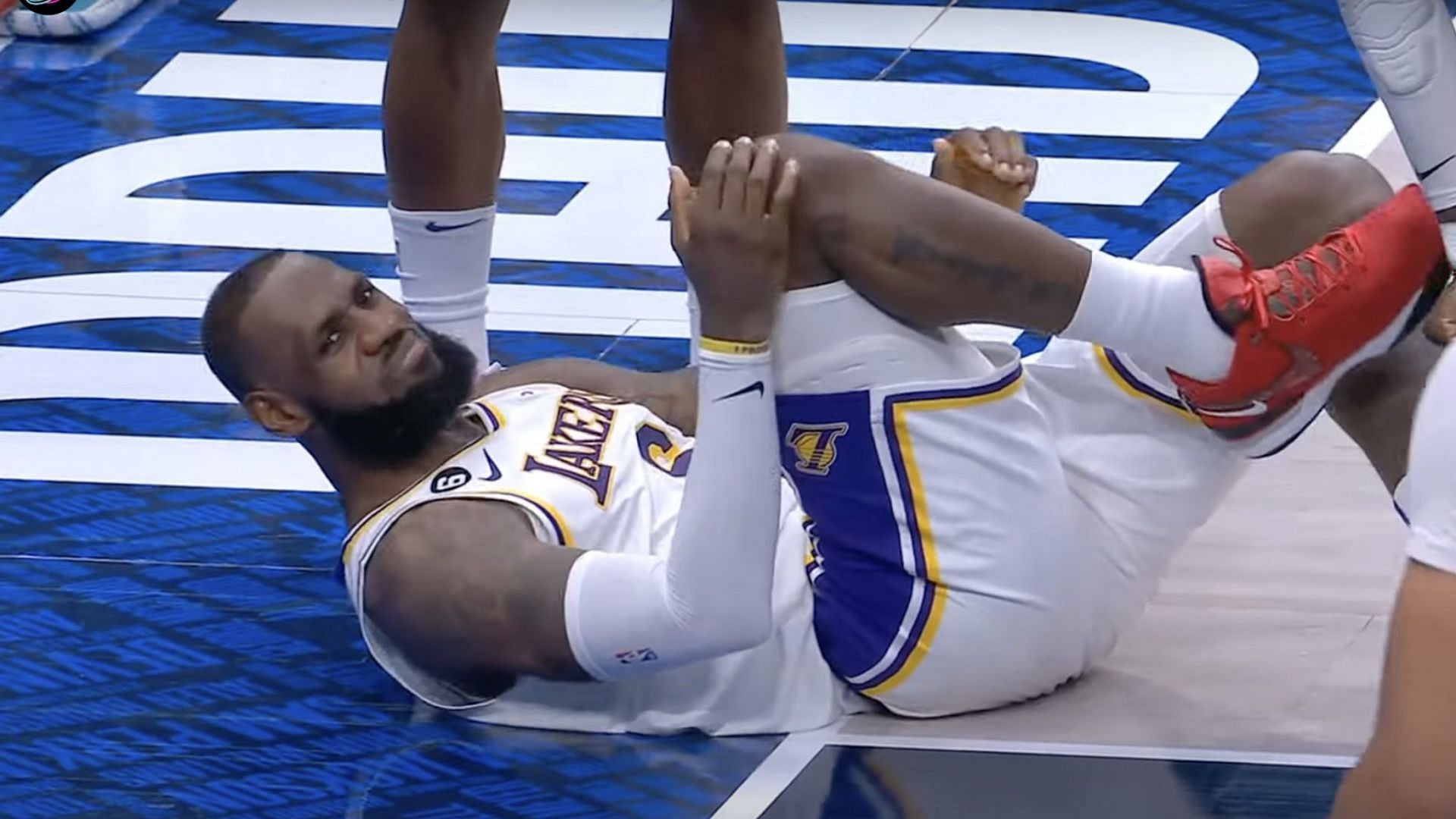 LA Lakers star forward LeBron James grimacing in pain following an apparent right foot injury on Sunday versus Dallas