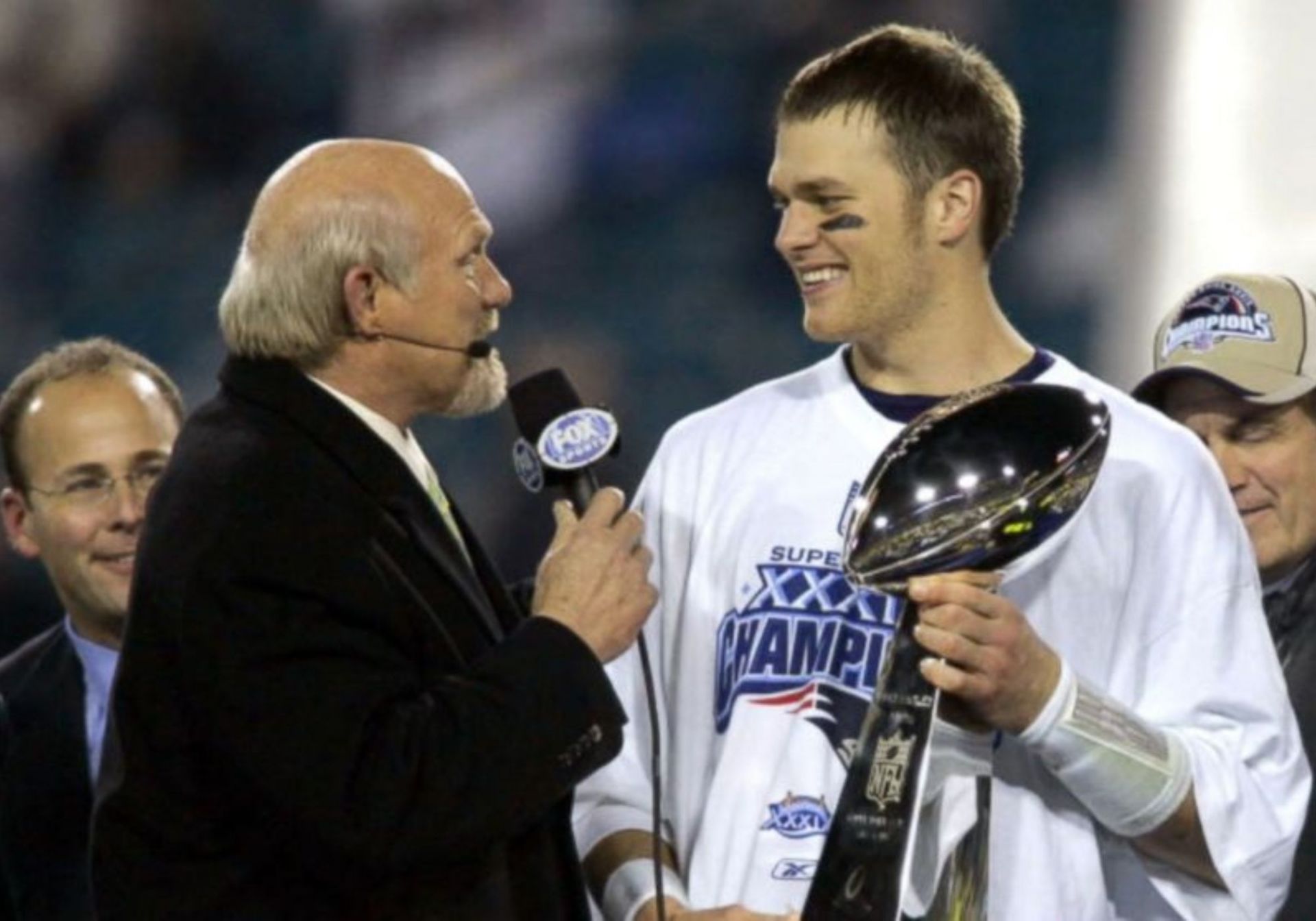 Tom Brady (R) winning his third Super Bowl title in 2005