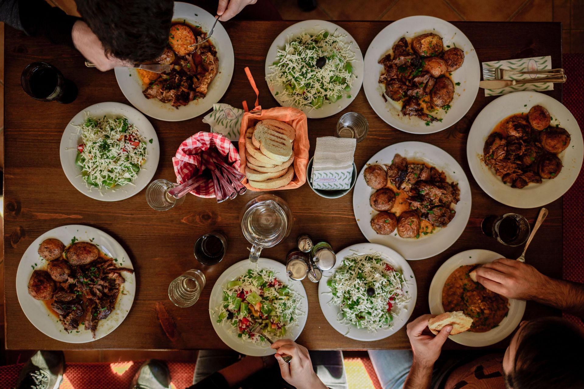 Communal eating provides a variety of foods to choose from. (Image via Unsplash/Stefan Vladimirov)