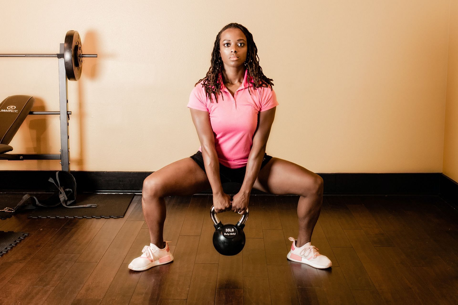 Sumo squats activate both the inner thighs and quads (Photo via Unsplash/Meagan Stone)