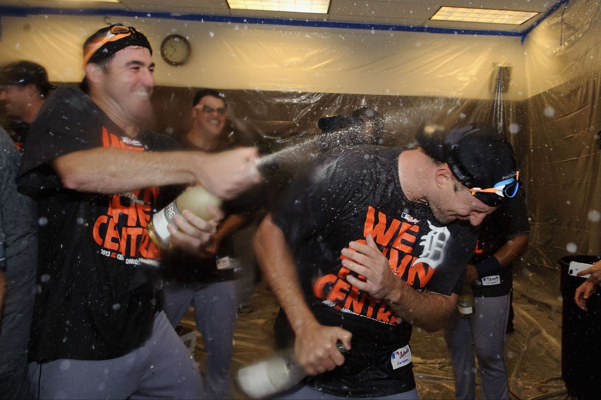 Justin Verlander #35 and Max Scherzer #37 of the Detroit Tigers celebrate with champagne in the clubhouse after a win against the Minnesota Twins on September 25, 2013 at Target Field in Minneapolis, Minnesota. The Tigers clinched the American League Central Division title with a 1-0 win over the Twins