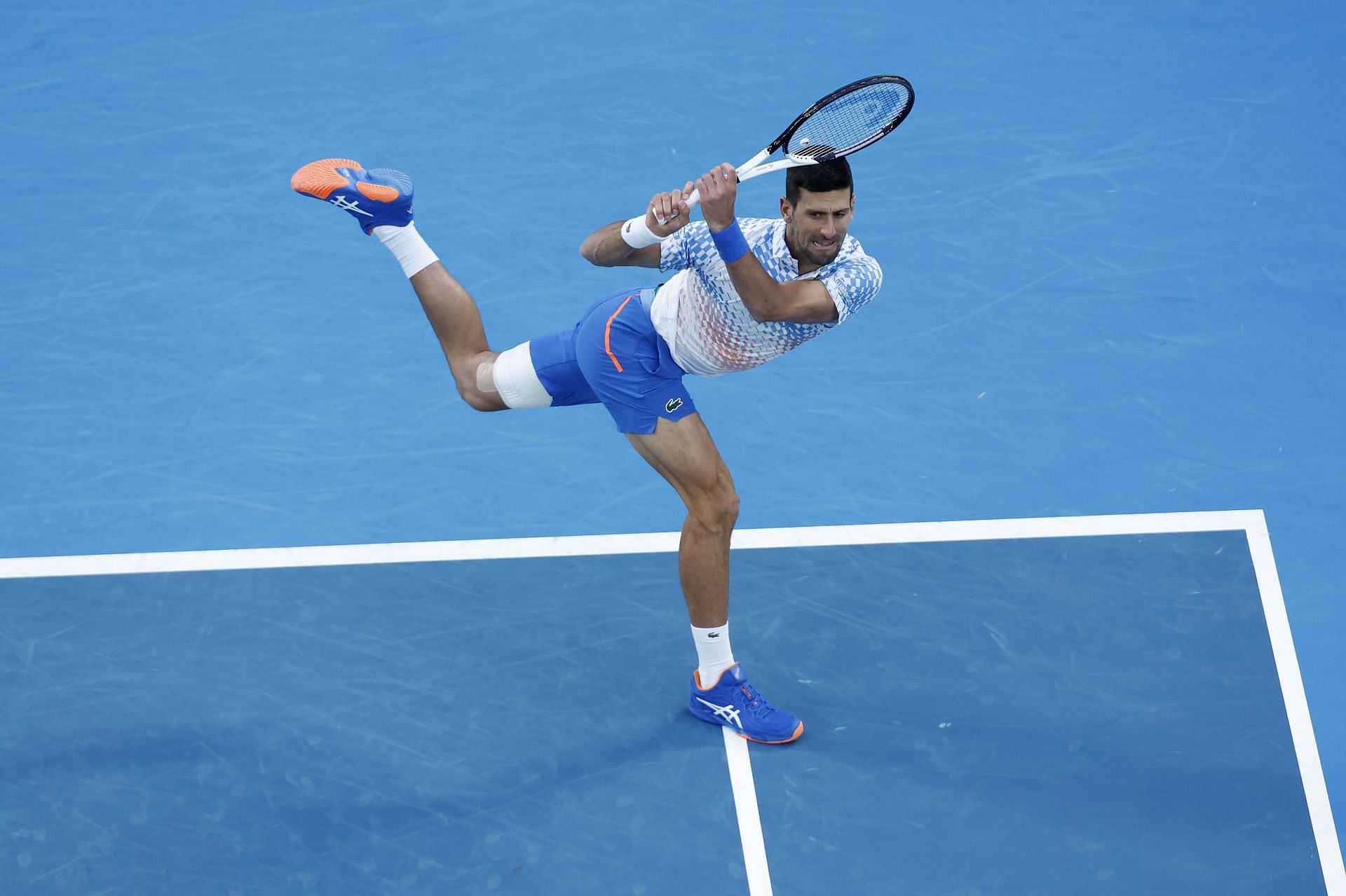 Novak Djokovic in action against Enzo Couacaud at the 2023 Australian Open.