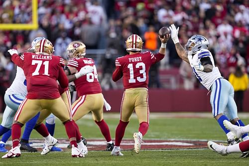 49ers' Brock Purdy unloads a pass over the outstretched arm of Cowboys' Micah Parsons