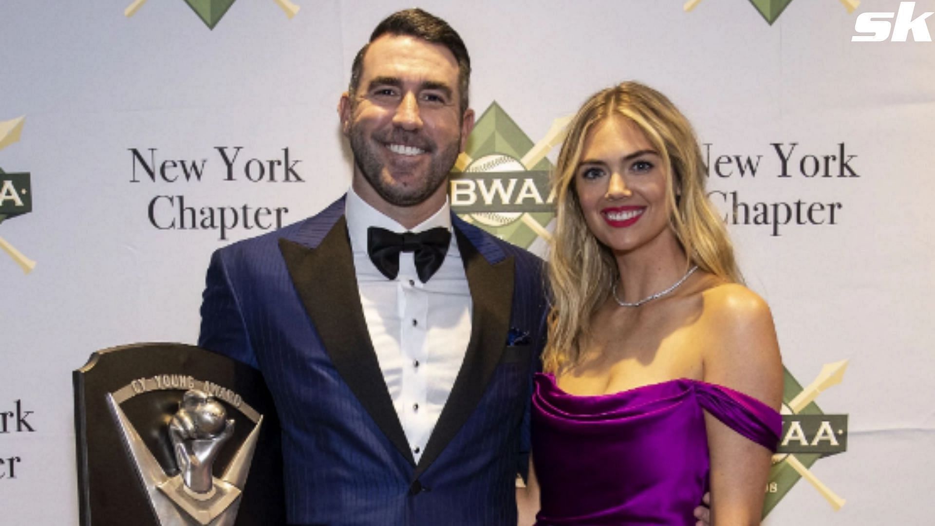 Justin Verlander poses with his wife Kate Upton and his American League Cy Young Award during the 2023 Baseball Writers