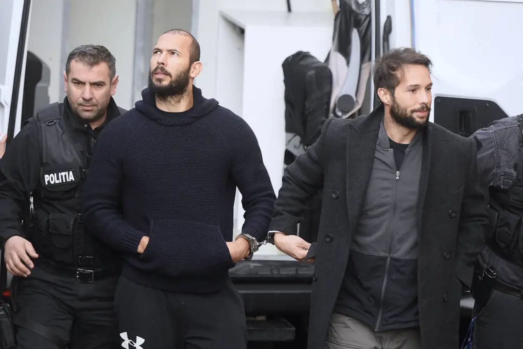 The Tate brothers on their way to court on Wednesday (Image via Vadim Ghirda/AP)