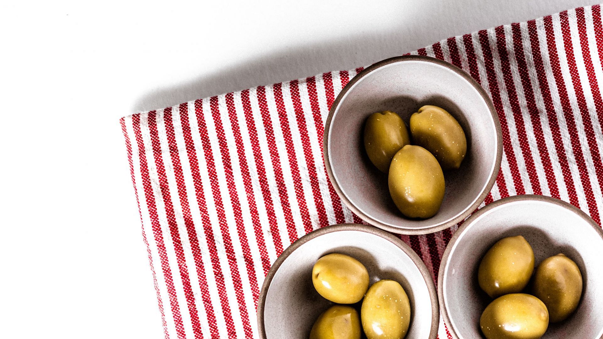 Green olives are used to produce olive oil. (Image via Unsplash/Kier in Sight)