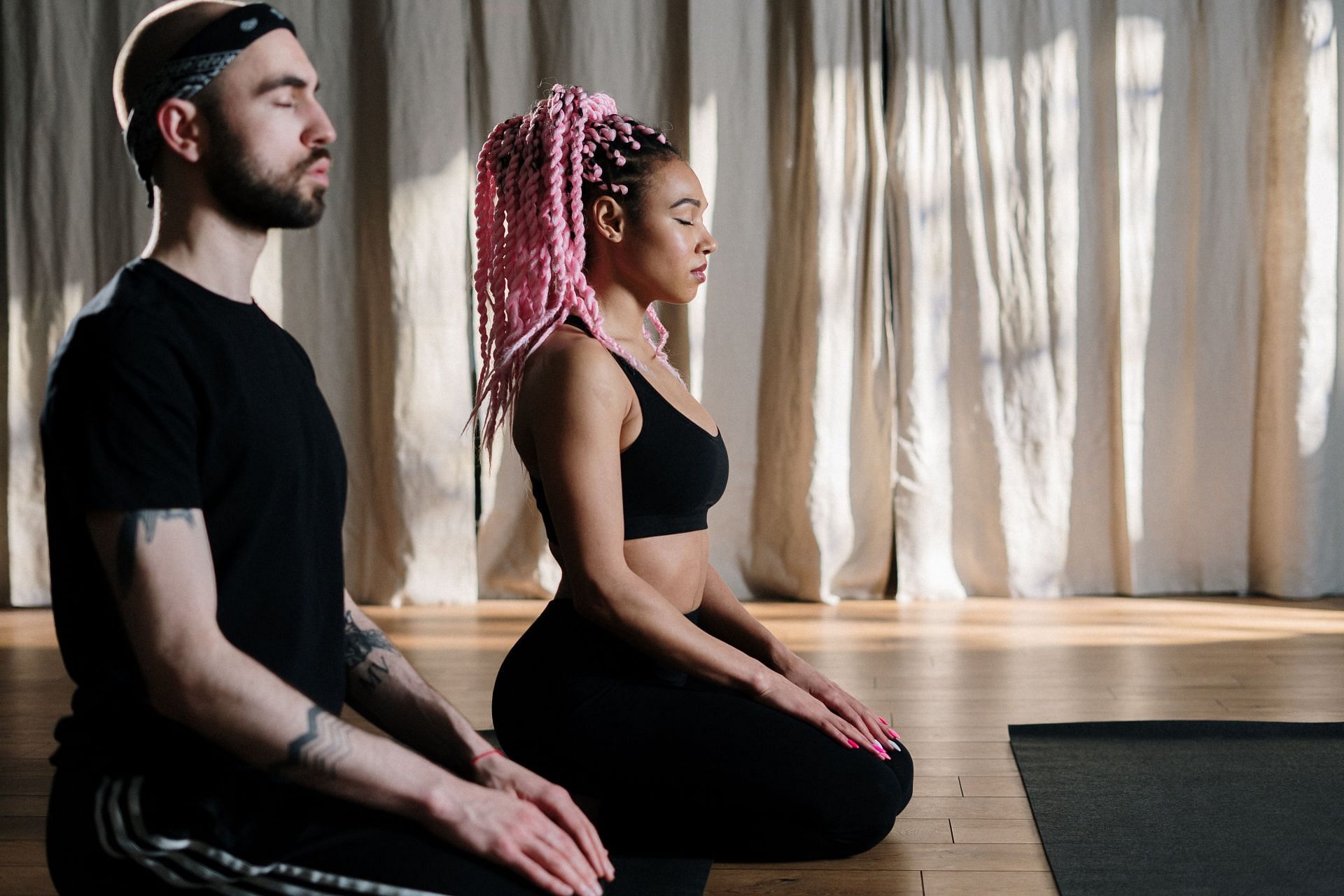 Couple performing yoga for breathing. (Image via Pexels/ Cottonbro Studio)
