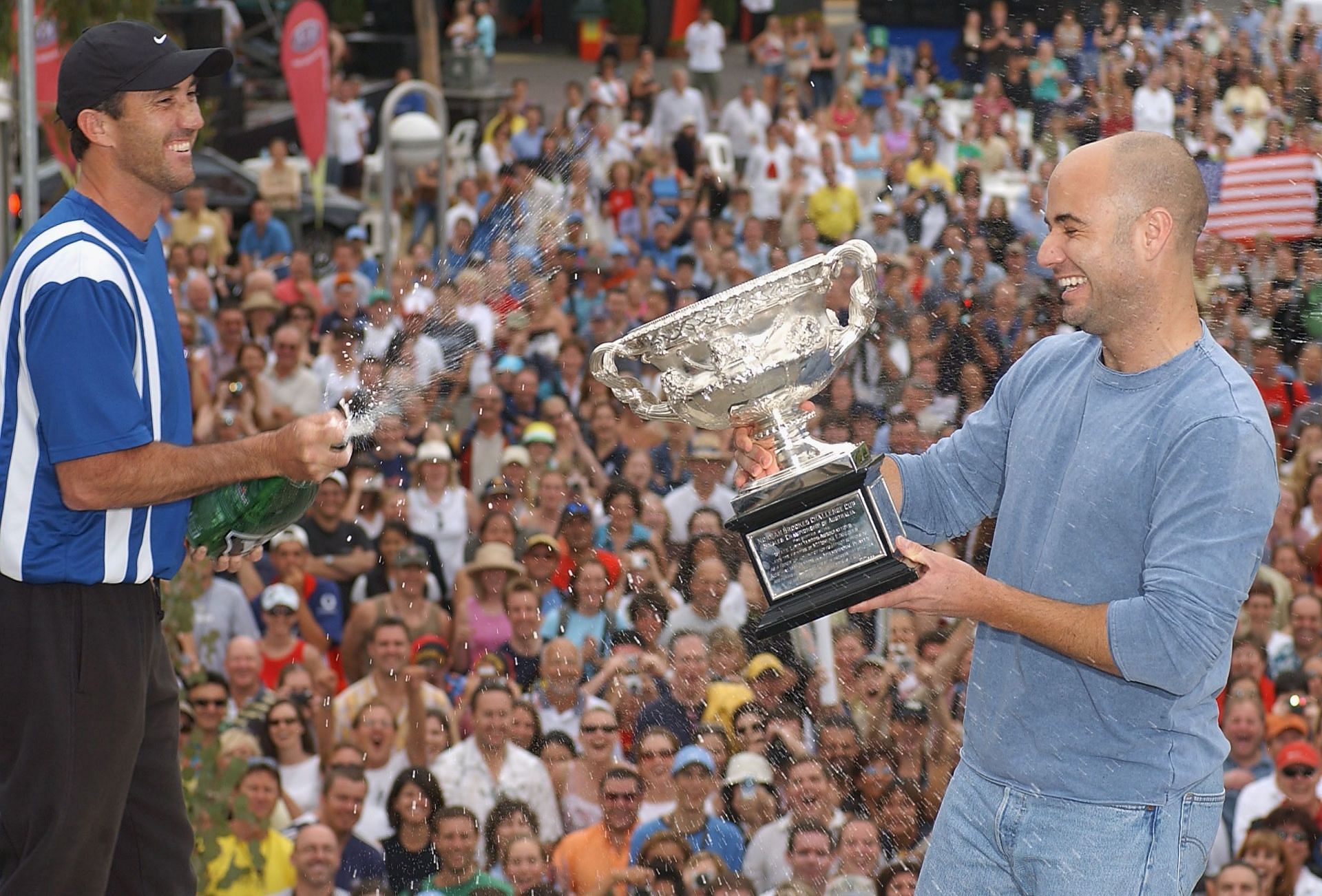 Darren Cahill sprays champagne over Andre Agassi following the latter&#039;s 2003 Australian Open triumph.