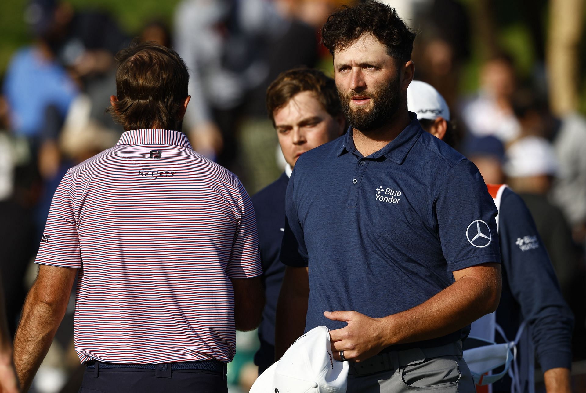 Max Homa shakes hands with Jon Rahm at the 2023 Genesis Invitational - Round Three