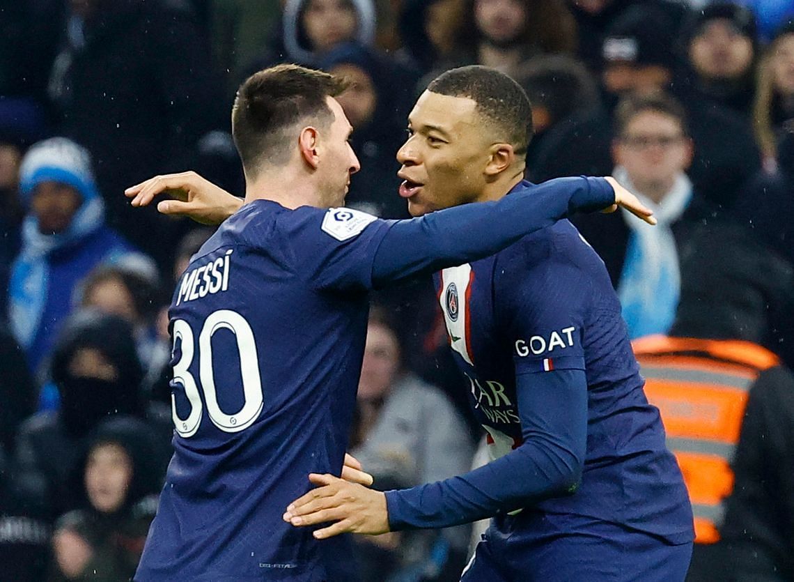 Lionel Messi and Kylian Mbappe celebrate PSG