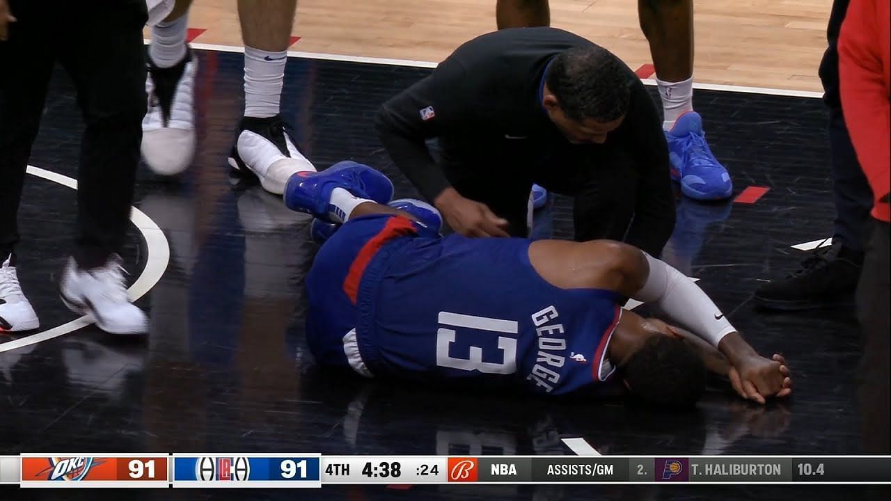 LA Clippers star wing Paul George laying on the court following an apparent right knee injury on Tuesday night