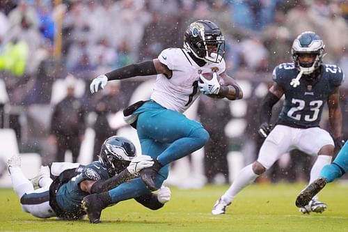 Kyzir White #43 of the Philadelphia Eagles tackles Travis Etienne Jr. #1 of the Jacksonville Jaguars